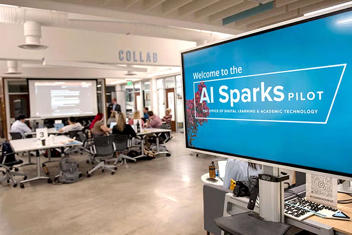Photo of AI Sparks signage and meeting attendees at the FSU Innovation Hub