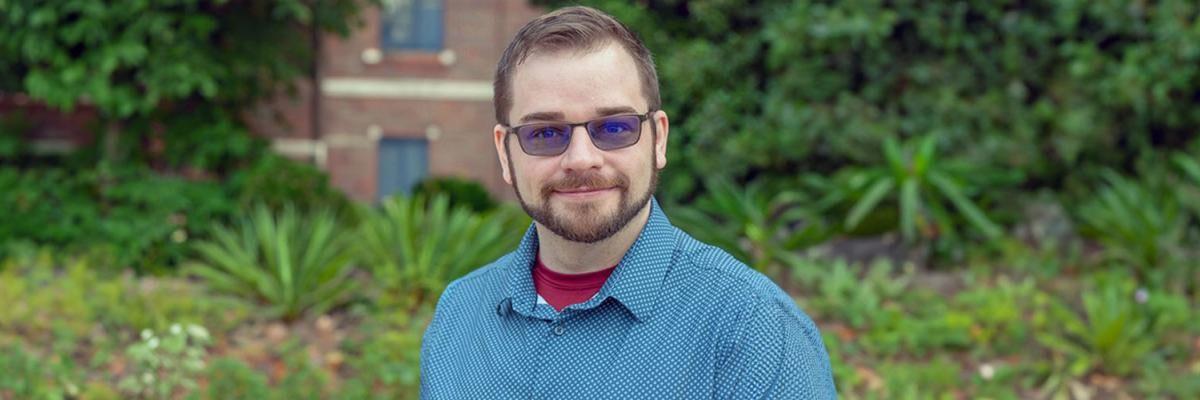 Image of Derek Kooi standing in front of an FSU building
